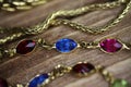 Close up isolated group gold precious jewellery chains and colorful gem bracelet on wood table Royalty Free Stock Photo