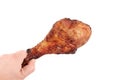 Close up and isolated image of hand holding a grilled chicken leg on white background. Royalty Free Stock Photo