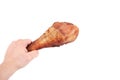 Close up and isolated image of hand holding a grilled turkey leg on white background. Royalty Free Stock Photo