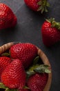 a wooden wooden bowl filled with fresh raw strawberries