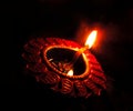 Close up isolated low key dipavali or diwali oil clay lamp Royalty Free Stock Photo