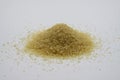 Close up of isolated pile brown sugar crystals, white background