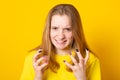 Close up isolated portrait of young annoyed angry woman holding hands in furious gesture.