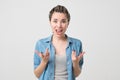 Close up isolated portrait of young caucasian annoyed angry woman holding hands in furious gesture. Royalty Free Stock Photo