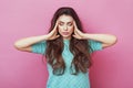 Close up isolated portrait of young stressed angry woman holding hands on head. Negative human emotions, headache face expressions Royalty Free Stock Photo