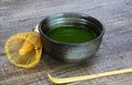 Close up of isolated set for brewing green Matcha tea: one bamboo whisk and scoop, ceramic bowl on old wood table Royalty Free Stock Photo