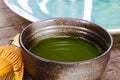 Close up of isolated set for brewing green Matcha tea: one bamboo whisk and scoop, ceramic bowl on old wood table Royalty Free Stock Photo