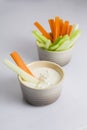 Close up isolated shot of a bowl of crunchy orange carrot slices and juicy green celery sticks with a carrot and celery piece Royalty Free Stock Photo