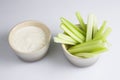 Close up  top view shot of a bowl of crunchy juicy green celery sticks next to a white cup of blue cheese dipping sauce on Royalty Free Stock Photo