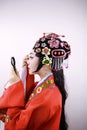 Close-up isolated white background Beijing opera Chinese female actress woman makeup comb traditional headwear costume drama show Royalty Free Stock Photo