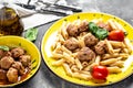 Close-up of Italian pasta with tomato sauce and meatballs on a yellow plate and a gray background. Food recipe background. Close Royalty Free Stock Photo