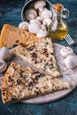 Close up italian pizza with mushrooms and cheese on a round board. Fork, knife and napkin. Pizza time concept Royalty Free Stock Photo