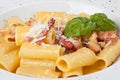 Close-up italian rigatoni plate with prosciutto, parmesan cheese