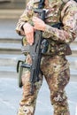 Close up of an Italian soldier in a city with an automatic rifle, emergency state concept