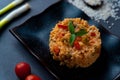Close up of italian vegan spring risotto on black dish with red pepper with sage leaves on dark background. healthy and fresh Royalty Free Stock Photo