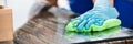 Close-up Of A Janitor Cleaning Desk With Cloth Royalty Free Stock Photo