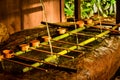 Close up of a Japanese Buddhist water purification pavillon at a temple with bamboo spoons