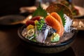 Close-up of Japanese food mixed Sashimi dish on blurred background, thinly sliced raw fish seafood served on ice with a little bit