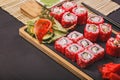 Close-up japanese sushi roll set with red flying fish caviar. Pickled ginger, spicy wasabi paste and soy sauce. Copy space Royalty Free Stock Photo