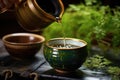 close-up of a japanese teapot pouring green tea into a ceramic cup Royalty Free Stock Photo