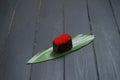 Close up of Japanese Tobiko Gunkan Sushi on bamboo leaf, dark wooden board. Royalty Free Stock Photo