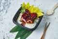 Close up on Japanese white rice with eel in teriyaki sauce and mango in lunchbox on white background. Copy space. Street food Royalty Free Stock Photo