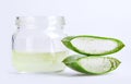 Close up jar of aloe vera gel with sliced aloe vera leaf isolated on white background with clipping path.