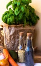 Close up jar of basil, bread,.spring onion, avocado, orange onion, garlic and carrot. Pasta jar and glass bottles with nuts and