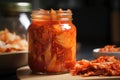 close-up of jar of kimchi, with its spicy flavor and crunchy texture visible