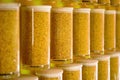 Close-up of a jar of sun-dried osmanthus flowers with a full wall