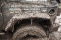 Close up of Jeep wheel stuck in a deep muddy pit. Royalty Free Stock Photo