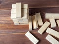 Close-up of a jenga game made of wooden blocks on a wooden background