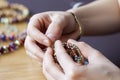 close-up of jewelry designer& x27;s hands, working with beads and thread