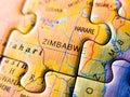 Close up of a jigsaw puzzle map depicting Zimbabwe and Africa Royalty Free Stock Photo