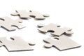 Close-up on jigsaw puzzle pieces, blank white paper jigsaw puzzle elements linked together and separate, Royalty Free Stock Photo