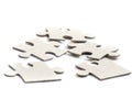 Close-up on jigsaw puzzle pieces, blank white paper jigsaw puzzle elements linked together and separate, Royalty Free Stock Photo