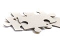 Close-up on jigsaw puzzle pieces, blank white paper jigsaw puzzle elements linked together and separate Royalty Free Stock Photo