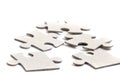 Close-up on jigsaw puzzle pieces, blank white paper jigsaw puzzle elements linked together and separate, Royalty Free Stock Photo