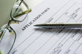 Close up of a job application form on desk with pen and glasses Royalty Free Stock Photo