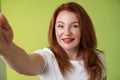 Close-up joyful enthusiastic redhead alluring middle-aged woman extand arm towards camera taking selfie smartphone