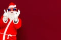 Close up joyful funny playful santa showing peace victory and zero signs, fooling around, in trendy specs, so confident