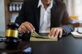 Close up of judge gavel and dollars on table. Law, auctioning, corruption, bankruptcy, bail, bribery or fines Royalty Free Stock Photo