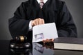 Judge Putting Money In Envelope Royalty Free Stock Photo