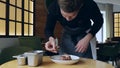 Close-up of a juicy freshly cooked steak. The male cook prepares the composition of the dish to be served. Steak with Royalty Free Stock Photo