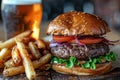Gourmet burger with artisan fries and craft beer on wooden table Royalty Free Stock Photo