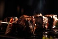 close-up of juicy grilled beef shishkabob, with lights and shadows playing on the meat