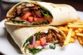 close-up of a juicy shawarma wrap on a white plate