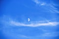 Close-up of the July sky. On a warm summer day, soft clouds and the moon met in a bright blue sky. Royalty Free Stock Photo