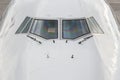 Close up of a jumbo jet nose, front view with windshield and wipers. Royalty Free Stock Photo