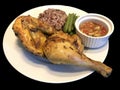 Kai yang in Thai or chicken grilled with spices and herbs served with brown sticky rice Royalty Free Stock Photo